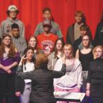 Audra Calloway directs the Soldotna High School Choir in a rehersal Oct. 11 at Soldotna High School. (Jake Dye/Peninsula Clarion)