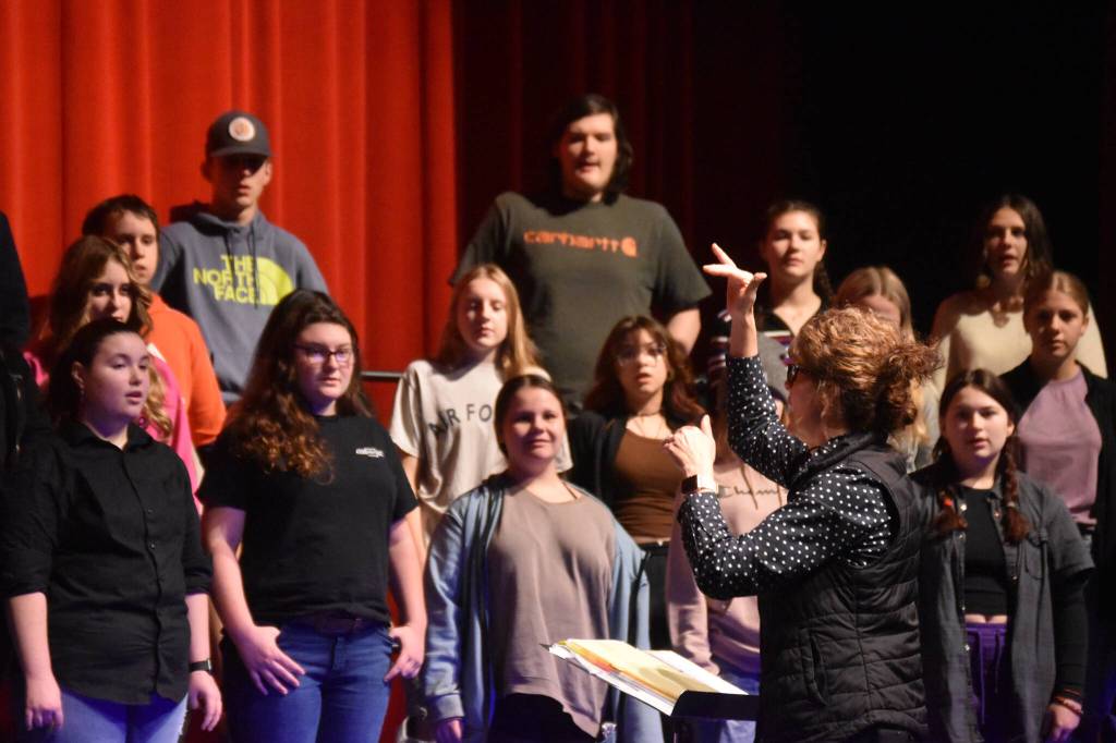 Audra Calloway directs the Soldotna High School Choir in a rehersal on Oct. 11, 2022, at Soldotna High School in Soldotna, Alaska. (Jake Dye/Peninsula Clarion)