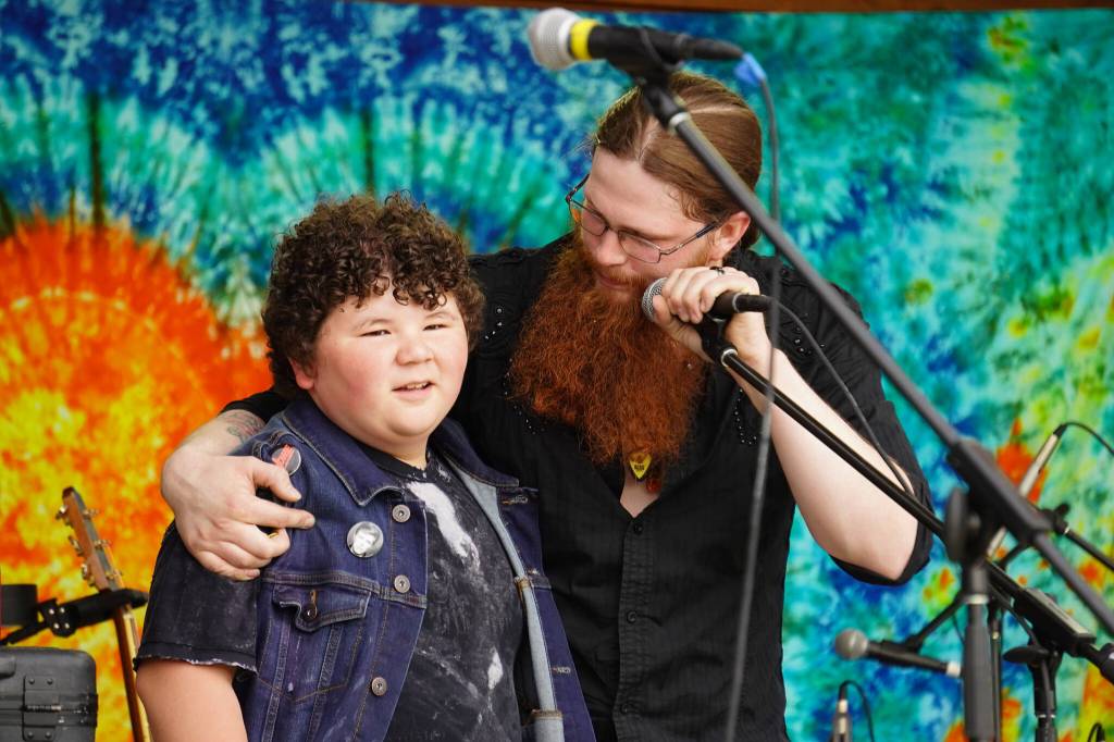 Kensington Smith, son of BenJammin & The Jammin Bands late drummer, Nuson Smith, is honored on stage during the Levitt AMP Soldotna Music Series on Wednesday, June 7, 2023, at Soldotna Creek Park in Soldotna, Alaska. Kensington was given a piece of the drum set Nuson had used from where it sat on the stage. (Jake Dye/Peninsula Clarion)