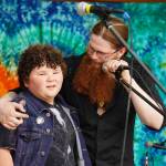 Kensington Smith, son of BenJammin & The Jammin Bands late drummer, Nuson Smith, is honored on stage during the Levitt AMP Soldotna Music Series on Wednesday, June 7, 2023, at Soldotna Creek Park in Soldotna, Alaska. Kensington was given a piece of the drum set Nuson had used from where it sat on the stage. (Jake Dye/Peninsula Clarion)