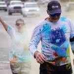 Participants are covered with colored powder during a color run held as part of during the Levitt AMP Soldotna Music Series on Wednesday, June 7, 2023, along the Sterling Highway in Soldotna, Alaska. (Jake Dye/Peninsula Clarion)