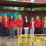 Members of the Kenai Central High School cheerleading team are awarded a legislative citation ahead of the start of the Soldotna Music Series performance on Wednesday, June 21, 2023, at Soldotna Creek Park in Soldotna, Alaska. (Jake Dye/Peninsula Clarion)
