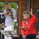 Rob Paulus and Connie Brannock, both part of Connie Brannocks Tiny House of Funk, perform during the Soldotna Music Series at Soldotna Creek Park in Soldotna, Alaska, on Wednesday, June 21, 2023. (Jake Dye/Peninsula Clarion)