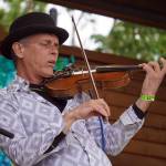 Rob Paulus, part of Connie Brannocks Tiny House of Funk, performs during the Soldotna Music Series at Soldotna Creek Park in Soldotna, Alaska, on Wednesday, June 21, 2023. (Jake Dye/Peninsula Clarion)