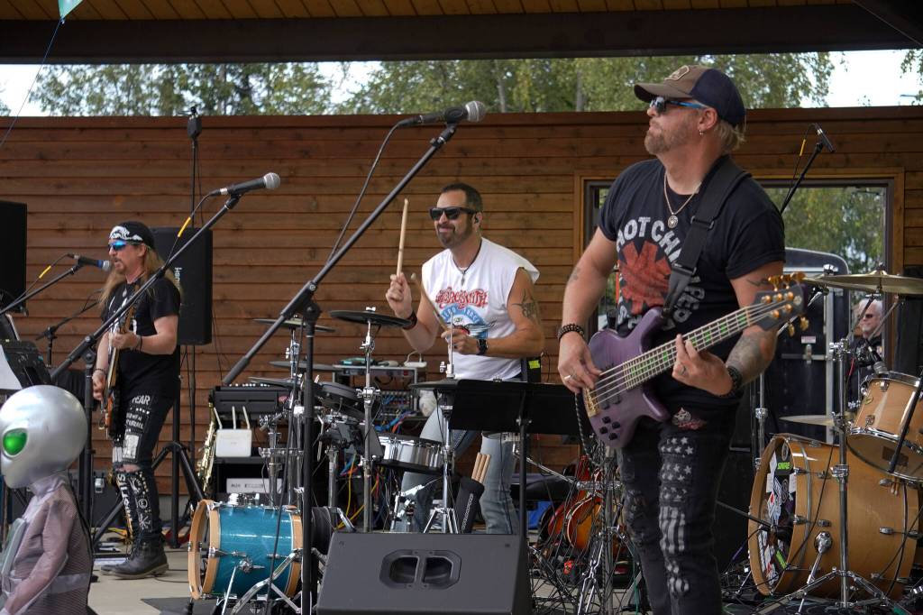 Scott Warner, Mark Gage and Ryan Bell perform as Hot Mess at Soldotna Creek Park in Soldotna, Alaska, on Wednesday, Aug. 23, 2023. (Jake Dye/Peninsula Clarion)