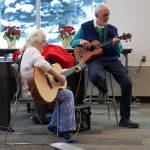 Elena Corey and Jim Pate perform during Music by the Fire at the Soldotna Public Library in Soldotna, Alaska, on Thursday, Dec. 21, 2023. (Jake Dye/Peninsula Clarion)