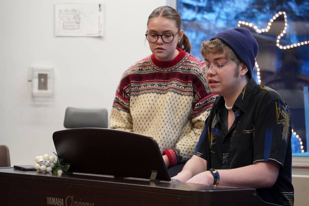 Hannah and Josiah Burton perform during Music by the Fire at the Soldotna Public Library in Soldotna, Alaska, on Thursday, Dec. 21, 2023. (Jake Dye/Peninsula Clarion)