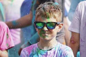 Participants are covered with colored powder during a color run held as part of during the Levitt AMP Soldotna Music Series on Wednesday, June 7, 2023, at the Kenai National Wildlife Refuge Visitors Center in Soldotna (Jake Dye/Peninsula Clarion)