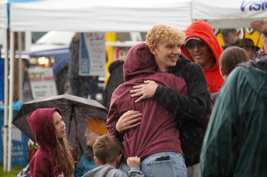 Attendees dance in the rain as Hope Social Club headlines the opening night of the 2024 Levitt AMP Soldotna Music Series at Soldotna Creek Park in Soldotna, Alaska, on Wednesday, June 5, 2024. (Jake Dye/Peninsula Clarion)