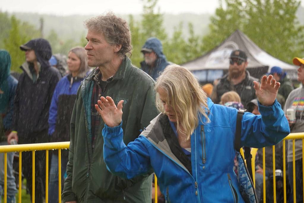 Attendees dance in the rain as Hope Social Club headlines the opening night of the 2024 Levitt AMP Soldotna Music Series at Soldotna Creek Park in Soldotna, Alaska, on Wednesday, June 5, 2024. (Jake Dye/Peninsula Clarion)