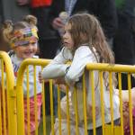 Children listen to Hope Social Club under rainfall during the opening night of the 2024 Levitt AMP Soldotna Music Series at Soldotna Creek Park in Soldotna, Alaska, on Wednesday, June 5, 2024. (Jake Dye/Peninsula Clarion)