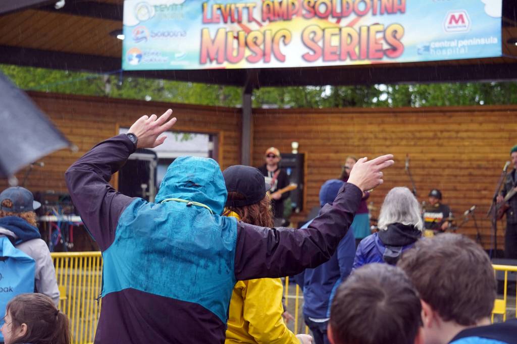Attendees dance in the rain as Hope Social Club headlines the opening night of the 2024 Levitt AMP Soldotna Music Series at Soldotna Creek Park in Soldotna, Alaska, on Wednesday, June 5, 2024. (Jake Dye/Peninsula Clarion)