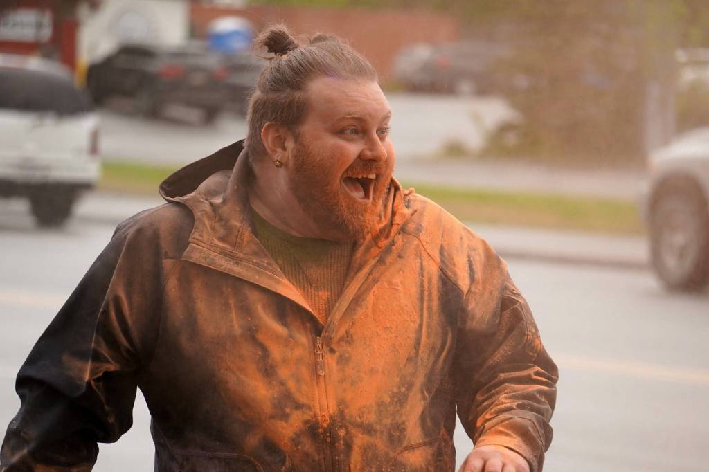 Joe Spady, initially tasked with coloring people, finds the color turned back towards himself during a color run as part of the opening night of the Levitt AMP Soldotna Music Series along the Sterling Highway in Soldotna, Alaska, on Wednesday, June 5, 2024. (Jake Dye/Peninsula Clarion)