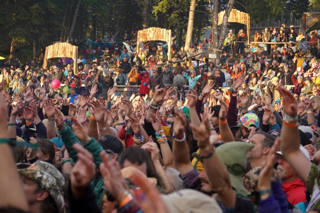 Hands reach out towards the River Stage at Salmonfest in Ninilchik, Alaska, on Saturday, Aug. 3, 2024. (Jake Dye/Peninsula Clarion)