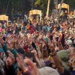 Hands reach out towards the River Stage at Salmonfest in Ninilchik, Alaska, on Saturday, Aug. 3, 2024. (Jake Dye/Peninsula Clarion)
