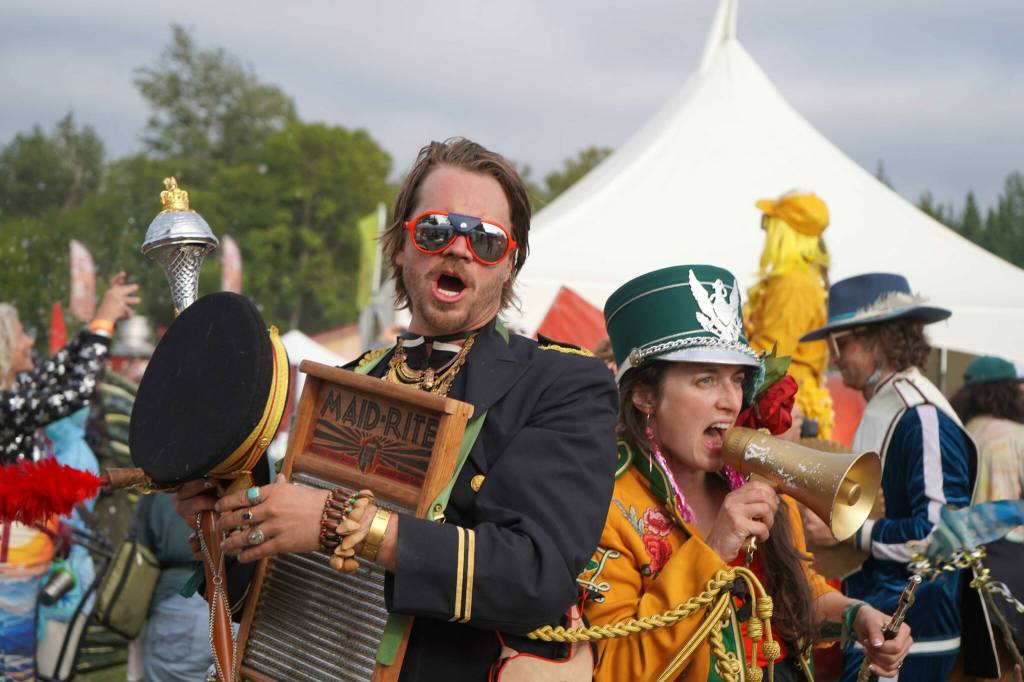 Members of the Salmonfest Marching Band parade through the fairgrounds at Salmonfest in Ninilchik, Alaska, on Saturday, Aug. 3, 2024. (Jake Dye/Peninsula Clarion)