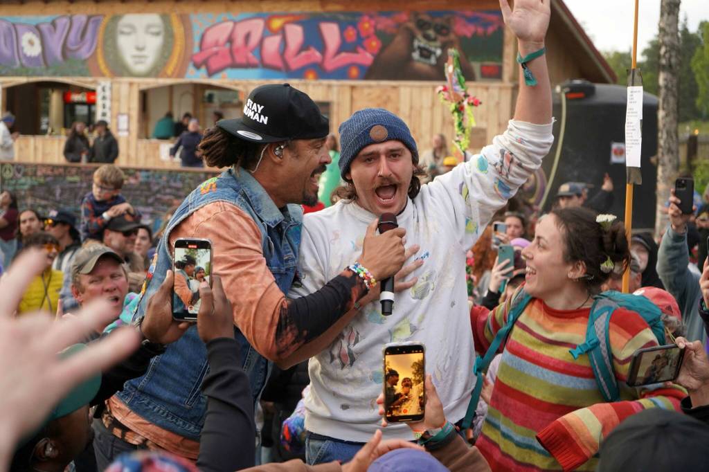 Michael Franti & Spearhead perform with members of the crowd at Salmonfest in Ninilchik, Alaska, on Saturday, Aug. 3, 2024. (Jake Dye/Peninsula Clarion)
