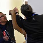 Kenai Peninsula College Associate Professor of Art Cambid-J Cam Choy unveils a piece of art he made to commemorate the Alan Tiqutsex Boraas Anthropology Lab at Kenai Peninsula College in Soldotna, Alaska, on Friday, Sept. 16, 2022. (Jake Dye/Peninsula Clarion)