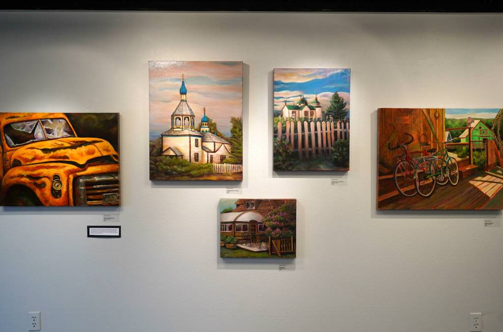 Artwork by Susie Scrivner for her exhibition, Portraits of the Kenai, fills the walls of the Kenai Art Center in Kenai, Alaska, on Thursday, Oct. 3, 2024. (Jake Dye/Peninsula Clarion)