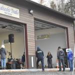 Jenny Neyman, administrative coordinator of the Tsalteshi Trails Association, speaks during a winter kick-off and open house event to celebrate a new maintenance shed Saturday, Oct. 12, 2024, just outside of Soldotna, Alaska. (Photo by Jeff Helminiak/Peninsula Clarion)