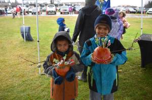 Two young contestants hold their pumpkins at the City of Kenais 9th annual Fall Pumpkin Festival in Kenai, Alaska, on Saturday, Oct. 12, 2024. (Photo by Jonas Oyoumick/Peninsula Clarion)