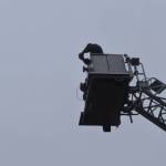 Kenai Vice Mayor Henry Knackstedt drops a small pumpkin from the basket of a fire truck at the 9th annual Fall Pumpkin Festival, Saturday, Oct. 12, 2024, in Kenai, Alaska. (Photo by Jonas Oyoumick/Peninsula Clarion)