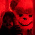 One frightening figure peers out from a doll house in the Haunted Chamber at the Kenai Chamber of Commerce and Visitor Center in Kenai, Alaska, on Friday, Oct. 18, 2024. (Jake Dye/Peninsula Clarion)