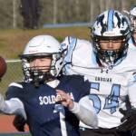 Soldotna's Owen Buckbee pitches the ball in front of Chugiak's Elijah Ortega in the Division II semifinal Saturday, Oct. 19, 2024, at Justin Maile Field at Soldotna High School in Soldotna, Alaska. (Photo by Jeff Helminiak/Peninsula Clarion)