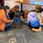 Families enjoyed exploring the sensory spider bin. (Photo courtesy Kenai National Wildlife Refuge)
