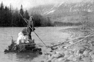 Keith McCullagh is photographed poling a raft down the Kenai River in 1911 during a forest survey. (U.S. Forestry Department photo by John Jack Brown)