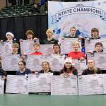 All of the individual champions, with the girls in the front, Division II wrestlers in the middle, and Division I winners in the back, pose with their brackets at the state wrestling tournament Saturday, Dec. 21, 2024, at the Alaska Airlines Center in Anchorage, Alaska. (Photo by Jeff Helminiak/Peninsula Clarion)