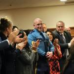 Alaska State Trooper Sgt. Jared Noll, center, is honored during Gov. Mike Dunleavys State of the State speech on Tuesday, Jan. 28, 2025, at the Alaska State Capitol. He is surrounded by members of Dunleavys Cabinet and other guests, including Dunleavys wife, Rose Dunleavy, third from left. (Klas Stolpe/Juneau Empire)