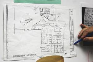 Kenai Middle School Principal Vaughn Dosko points out elements of a redesign plan for the front of the school on Wednesday, Sept. 21, 2022, in Kenai, Alaska. (Ashlyn OHara/Peninsula Clarion)