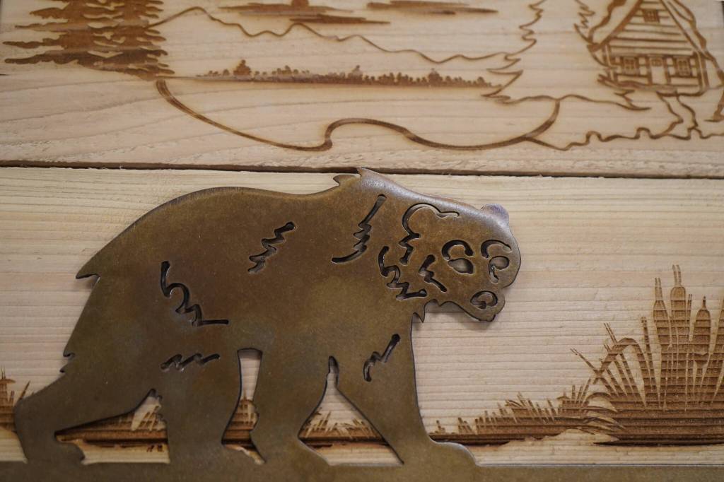 Signs crafted of wood and metal by Nikiski Middle/High School students are displayed during a meeting of the Kenai Peninsula Borough School Districts Board of Education in Soldotna, Alaska, on Monday, Feb. 3, 2025. (Jake Dye/Peninsula Clarion)