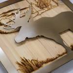 Signs crafted of wood and metal by Nikiski Middle/High School students are displayed during a meeting of the Kenai Peninsula Borough School Districts Board of Education in Soldotna, Alaska, on Monday, Feb. 3, 2025. (Jake Dye/Peninsula Clarion)