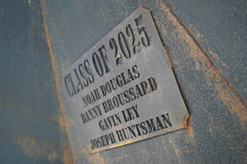 A plaque installed inside a massive firepit built by Class of 2025 Nikiski students includes their names and is seen at Nikiski Middle/High School in Nikiski, Alaska, on Tuesday, Feb. 11, 2025. (Jake Dye/Peninsula Clarion)
