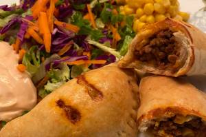 Beef empanadas are served with mixed greens and corn. (Photo by Tressa Dale/Peninsula Clarion)