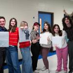 Nikiskis Jackson Hooper, Rainy Jenness, Belle Morris, Kry Spurgeon, Ava Spurgeon, Oshie Broussard and Kincaid Jenness stand for a photo during the Kenai Peninsula Borough School District Drama, Debate and Forensics Invitational at Soldotna High School on Saturday, Feb. 15, 2025. (Jake Dye/Peninsula Clarion)