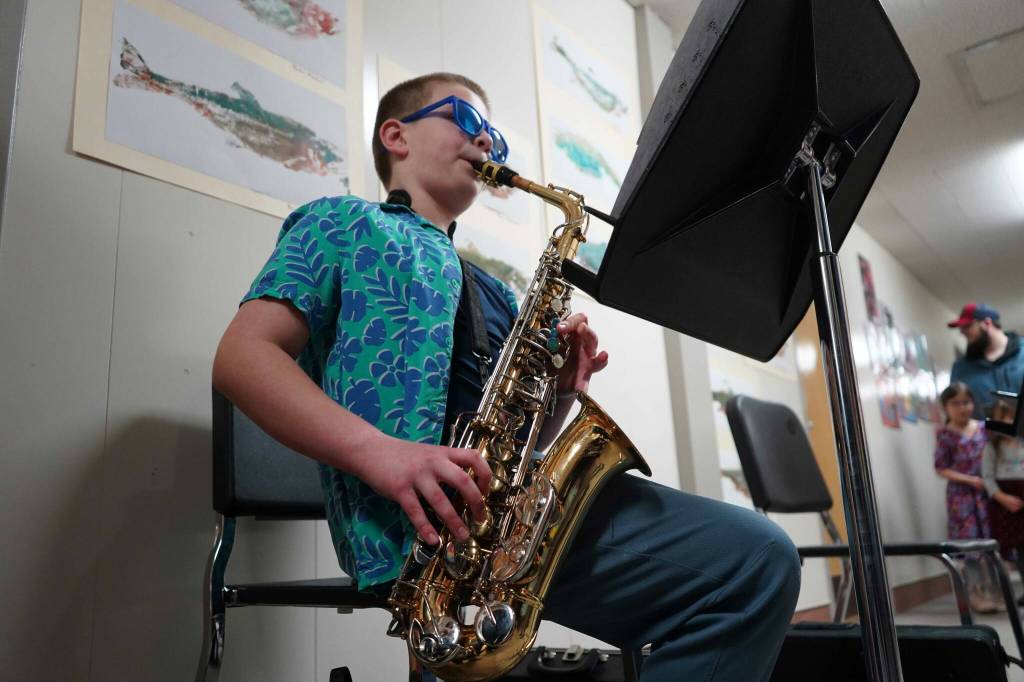 Soldotna Elementary School students perform in the halls during an art show and music fundraiser at Soldotna Elementary School in Soldotna, Alaska, on Thursday, Feb. 27, 2025. (Jake Dye/Peninsula Clarion)