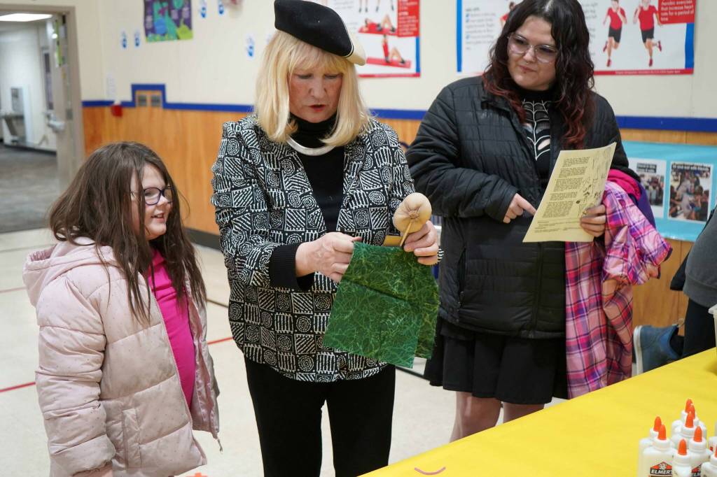 Students and families create puppets during a family art night hosted by Artist in Residence Shala Dobson, center, at Kaleidoscope School of Arts and Science in Kenai, Alaska, on Thursday, Feb. 27, 2025. (Jake Dye/Peninsula Clarion)
