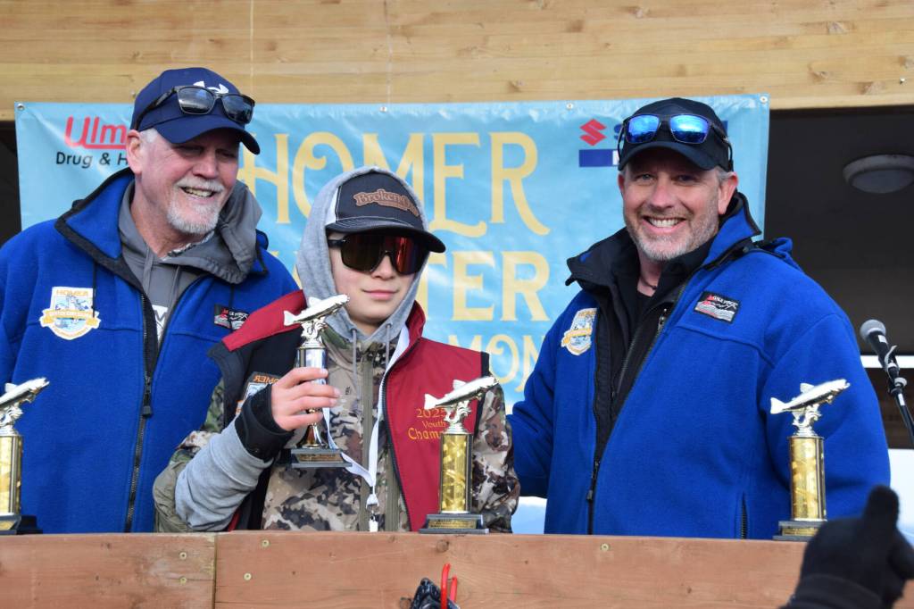 Rhys Borland (center) accepts the Top Youth Angler award during the 2025 Homer Winter King Salmon Tournament on Saturday, March 22, 2025, at the Deep Water Dock on the Homer Spit in Homer, Alaska. (Delcenia Cosman/Homer News)