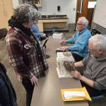 Gary Titus and Clark Fair sign copies of their new book at the Soldotna Public Library on March 5. (Photo courtesy of Clark Fair)