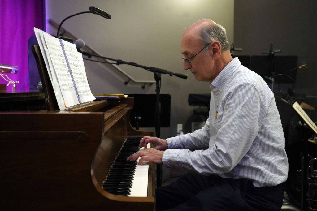 Triumvirate Theatre President Joe Rizzo plays piano during the opening of the new Triumvirate Theatre in Kenai, Alaska, on Saturday, April 19, 2025. (Jake Dye/Peninsula Clarion)
