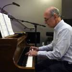 Triumvirate Theatre President Joe Rizzo plays piano during the opening of the new Triumvirate Theatre in Kenai, Alaska, on Saturday, April 19, 2025. (Jake Dye/Peninsula Clarion)