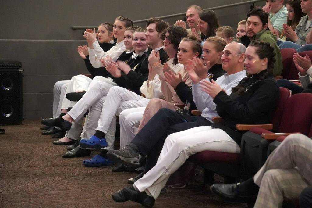 Triumvirate actors applaud during the opening of the new Triumvirate Theatre in Kenai, Alaska, on Saturday, April 19, 2025. (Jake Dye/Peninsula Clarion)