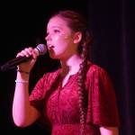 Ella Mallard performs during the opening of the new Triumvirate Theatre in Kenai, Alaska, on Saturday, April 19, 2025. (Jake Dye/Peninsula Clarion)