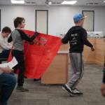 Students of Sterling Elementary School carry a sign in support of their school during a special meeting of the Kenai Peninsula Borough School District Board of Education in Soldotna, Alaska, on Wednesday, April 23, 2025. (Jake Dye/Peninsula Clarion)