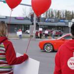 Parents and teachers protest the possible closure of Sterling Elementary School along the Sterling Highway in Soldotna, Alaska, on Saturday, May 3, 2025. (Jake Dye/Peninsula Clarion)