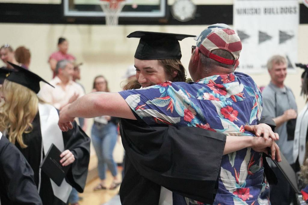Nikiski graduates embrace their supporters during a commencement ceremony at Nikiski/Middle High School in Nikiski, Alaska, on Monday, May 19, 2025. (Jake Dye/Peninsula Clarion)