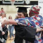 Nikiski graduates embrace their supporters during a commencement ceremony at Nikiski/Middle High School in Nikiski, Alaska, on Monday, May 19, 2025. (Jake Dye/Peninsula Clarion)